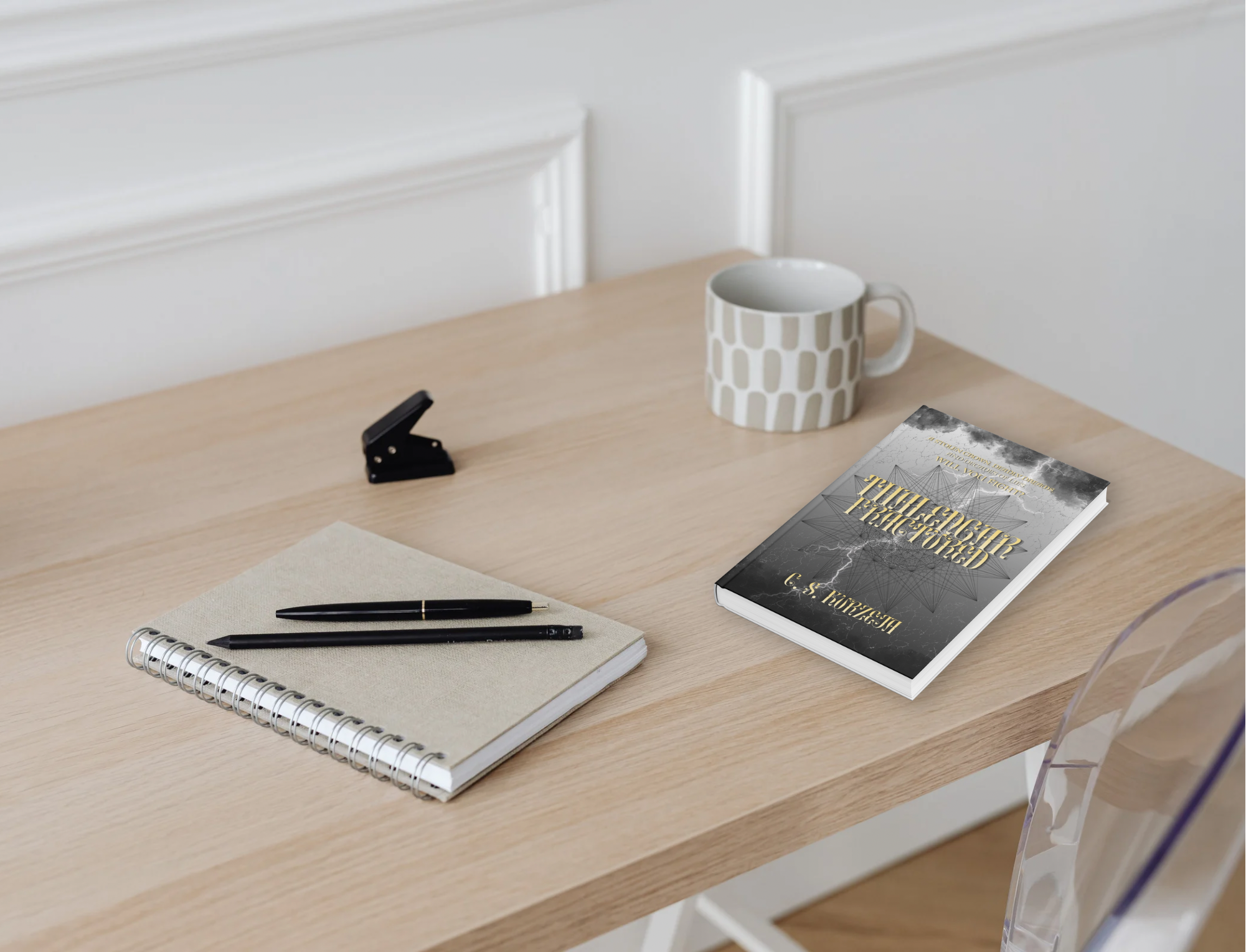 Paperback mock-up of Thalengar: Fractured by C. S. Kurzeja resting on a desk.
